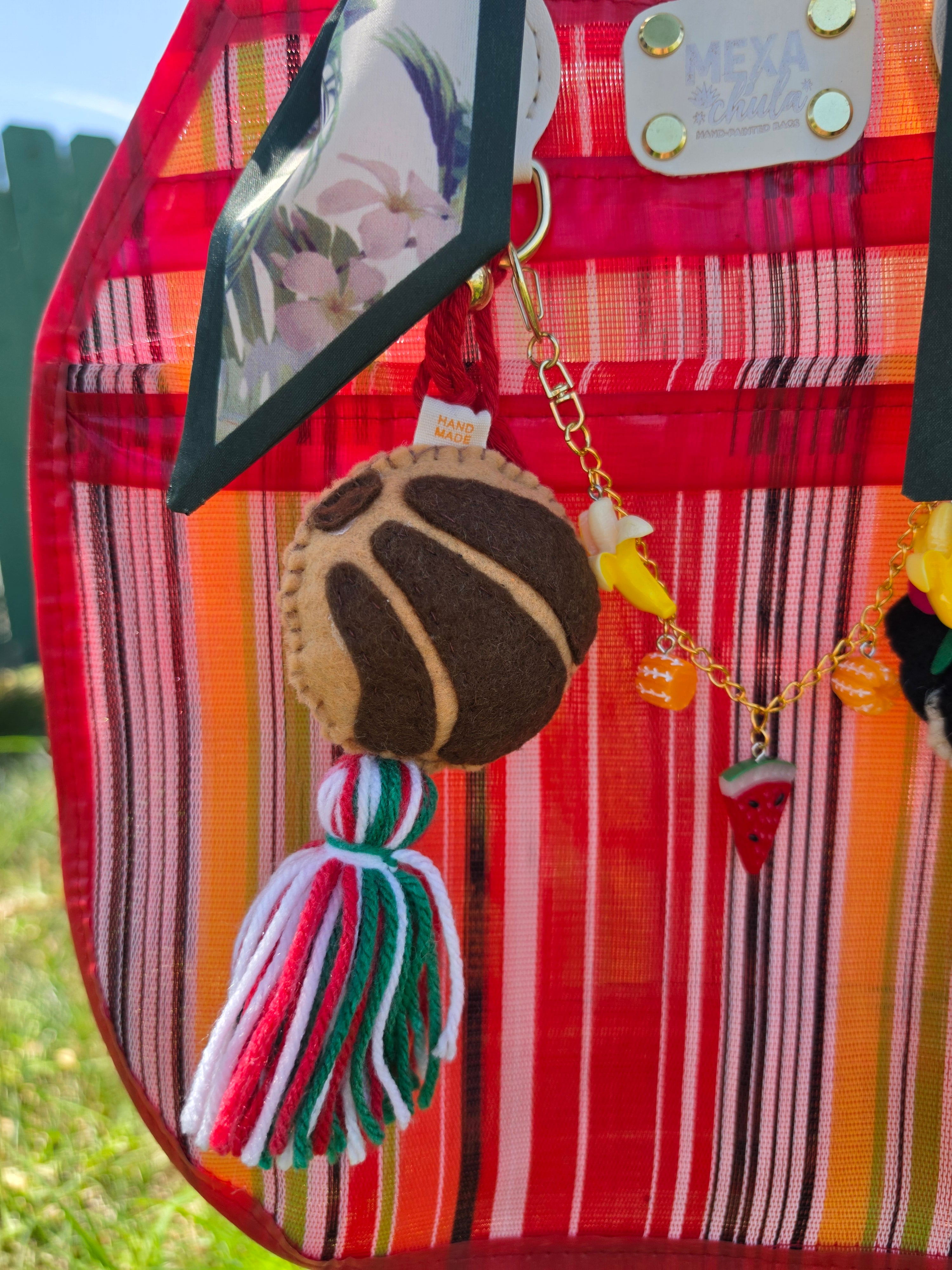 Charm de concha de pan dulce en fieltro con borla tricolor
